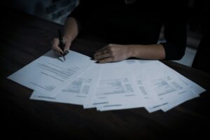 Property manager reviewing a rental application and verification documents at a desk
