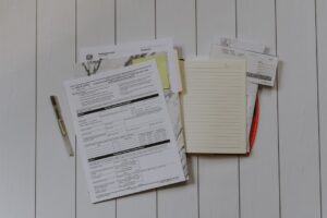 A person examining a kitchen with a clipboard during a rental property inspection.