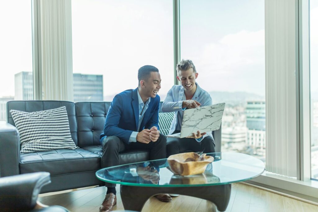 Property manager reviews a rental application and identification documents with a prospective tenant at a table.