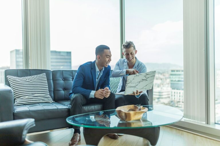 Property manager reviews a rental application and identification documents with a prospective tenant at a table.